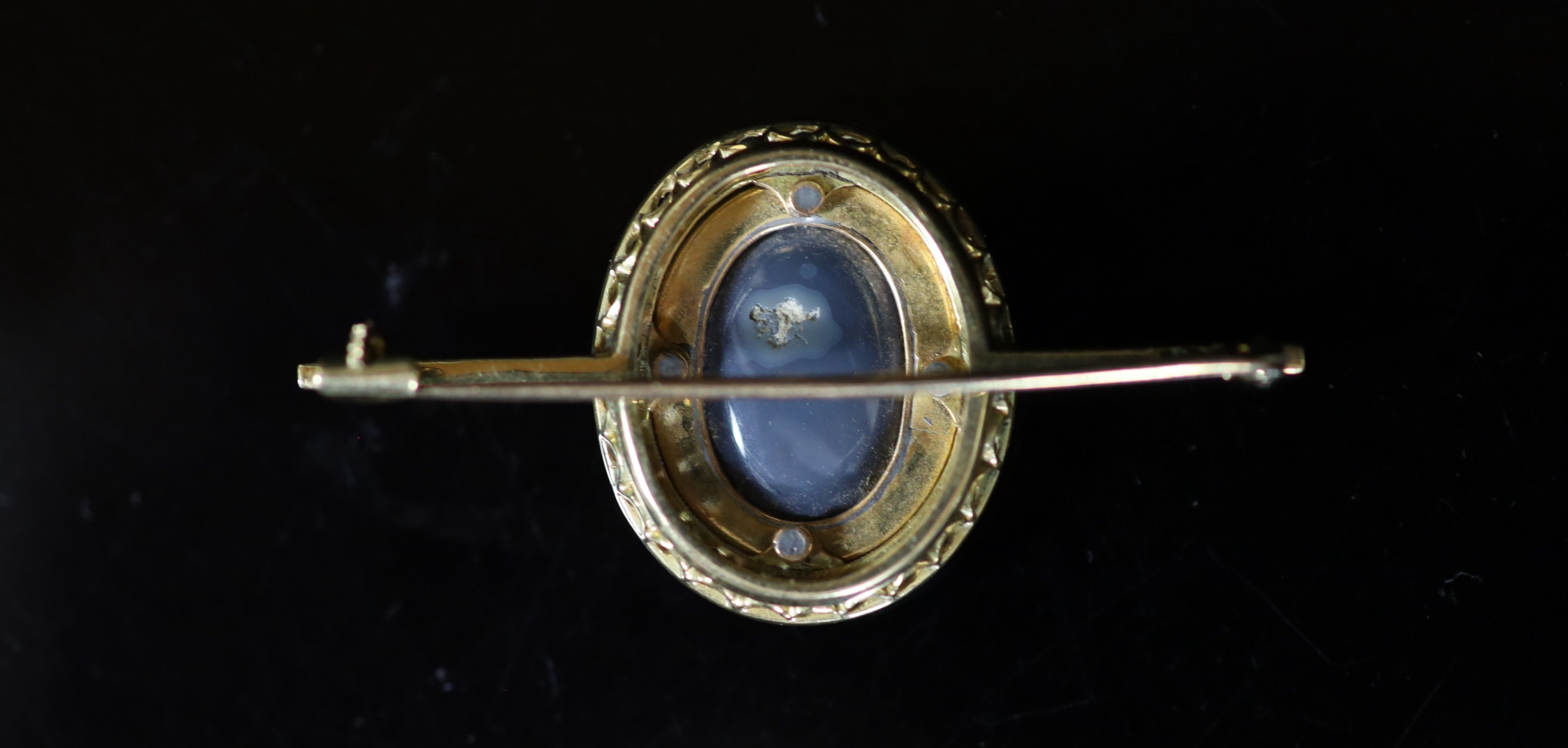 An early to mid 20th century gold, black opal doublet, blue enamel and millegrain sapphire set bar brooch